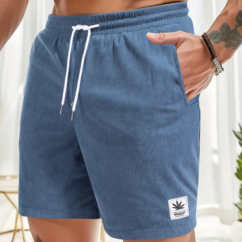 Man wearing grey straight leg drawstring summer shorts made from elastic fabric.