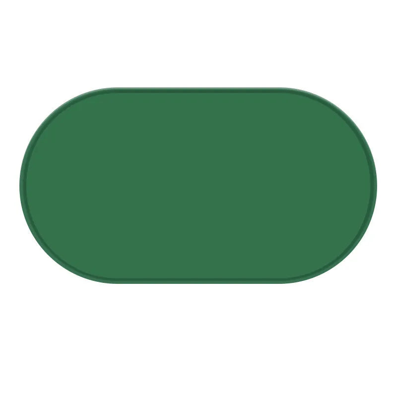 A green silicone placemat for cats with a non-slip base, shown under a food bowl.