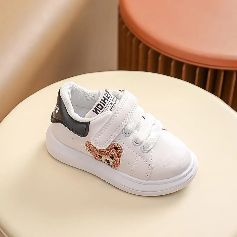 Children's black casual sports shoes with a cartoon bear design on the side, featuring an artificial leather upper and rubber sole.