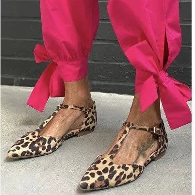 Leopard print women's pointed toe pumps with a low chunky heel and a cross ankle strap.