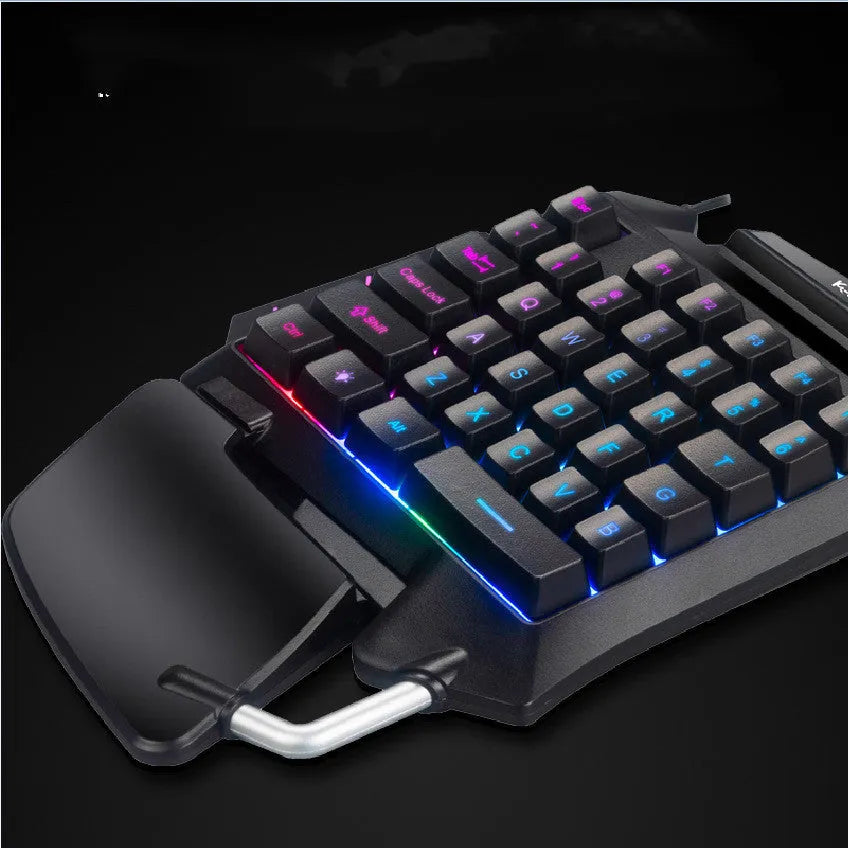 Black one-handed left-hand gaming keyboard with hand rest for desktop throne converter setup.