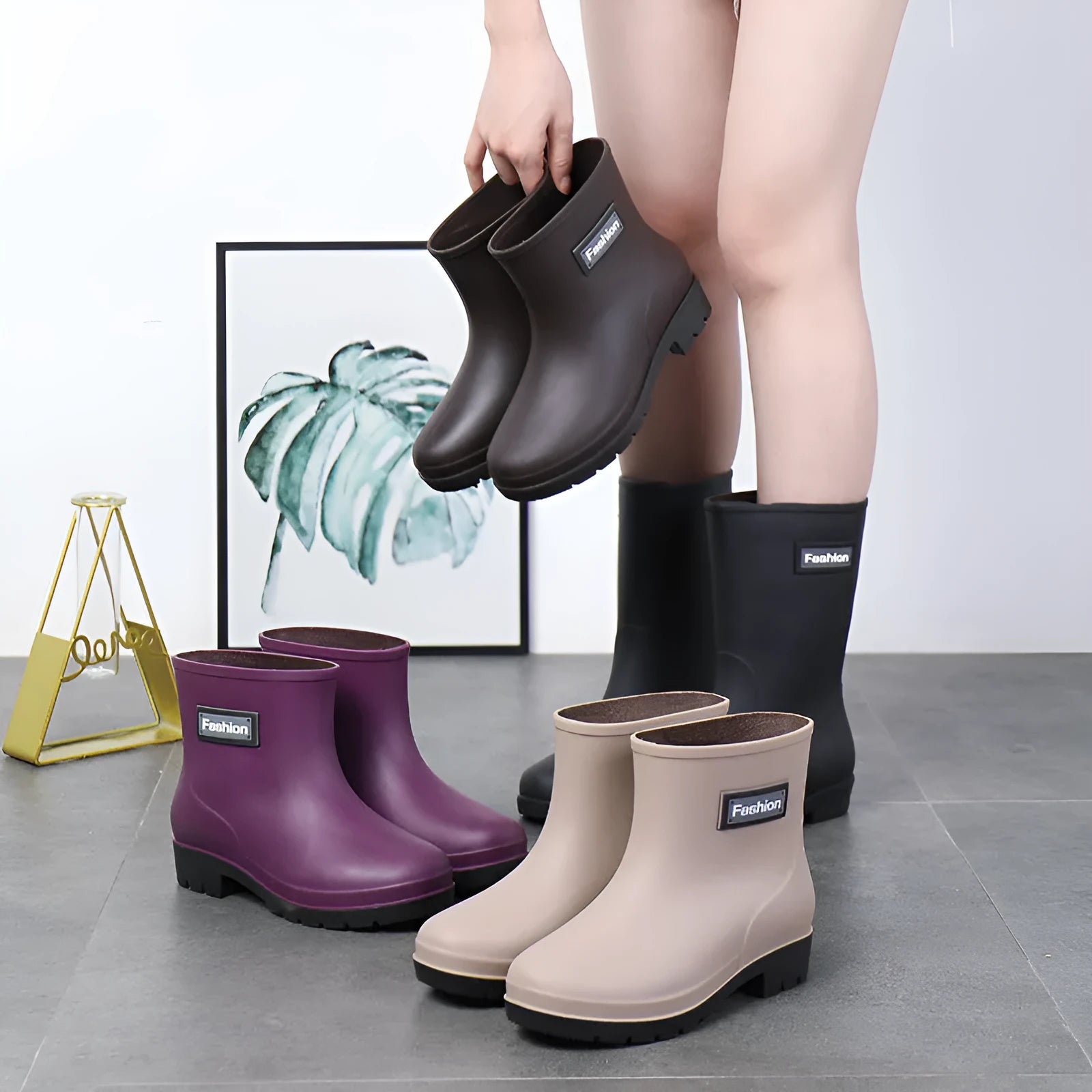 Women's black mid-calf rain boot made of PVC with a low heel.
