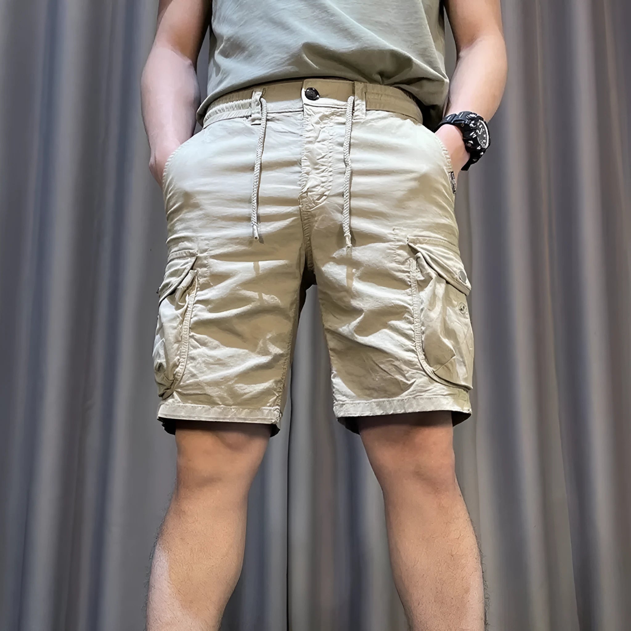 A model wearing loose, straight-leg multi-pocket casual overalls in a khaki colour.