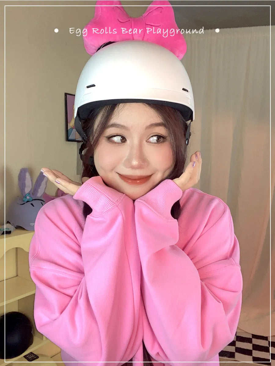 A soft plush bow decoration for helmets in red, peach pink, and rose pink colours.