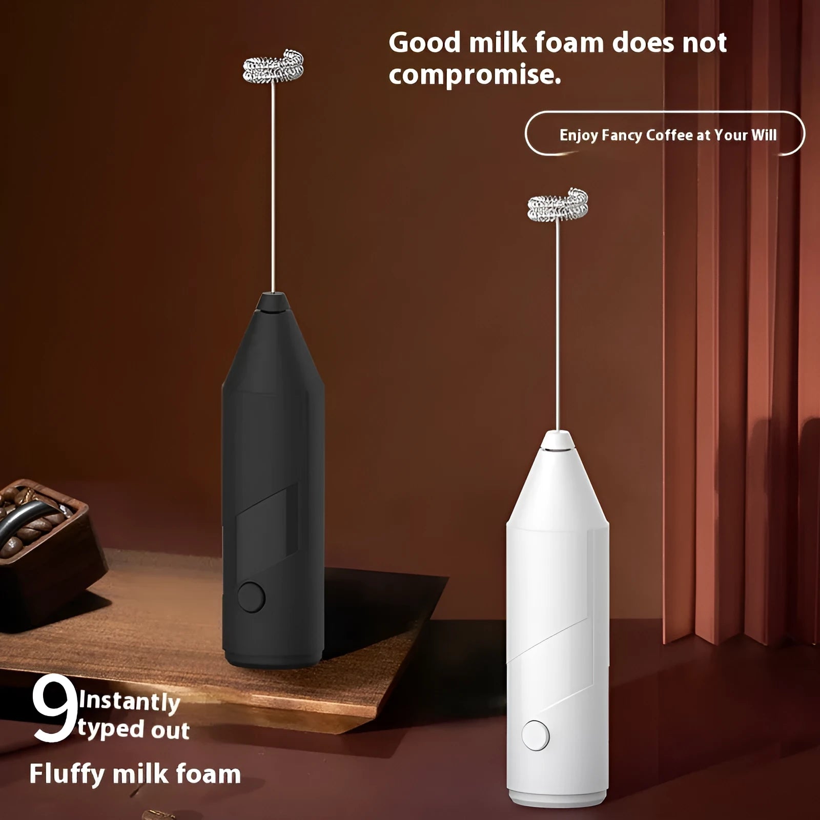 Compact black handheld electric milk frother with a stainless steel whisk and USB charging port.