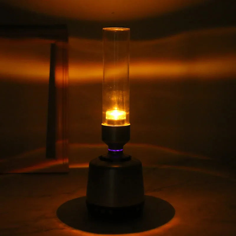 White silver cylindrical Bluetooth speaker night light with candlelight LED glow.