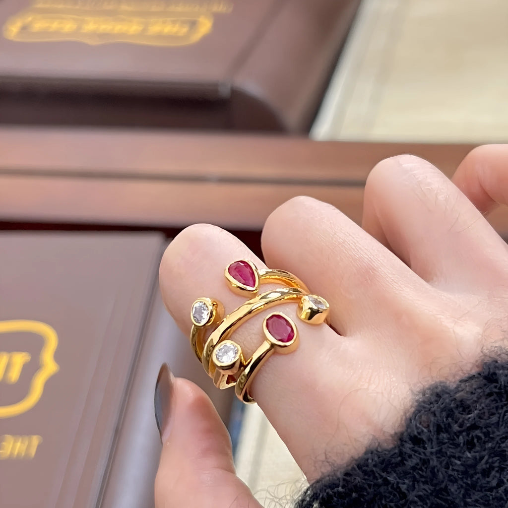 Geometric double-headed ring with irregular cross shape and two-colour electroplated finish