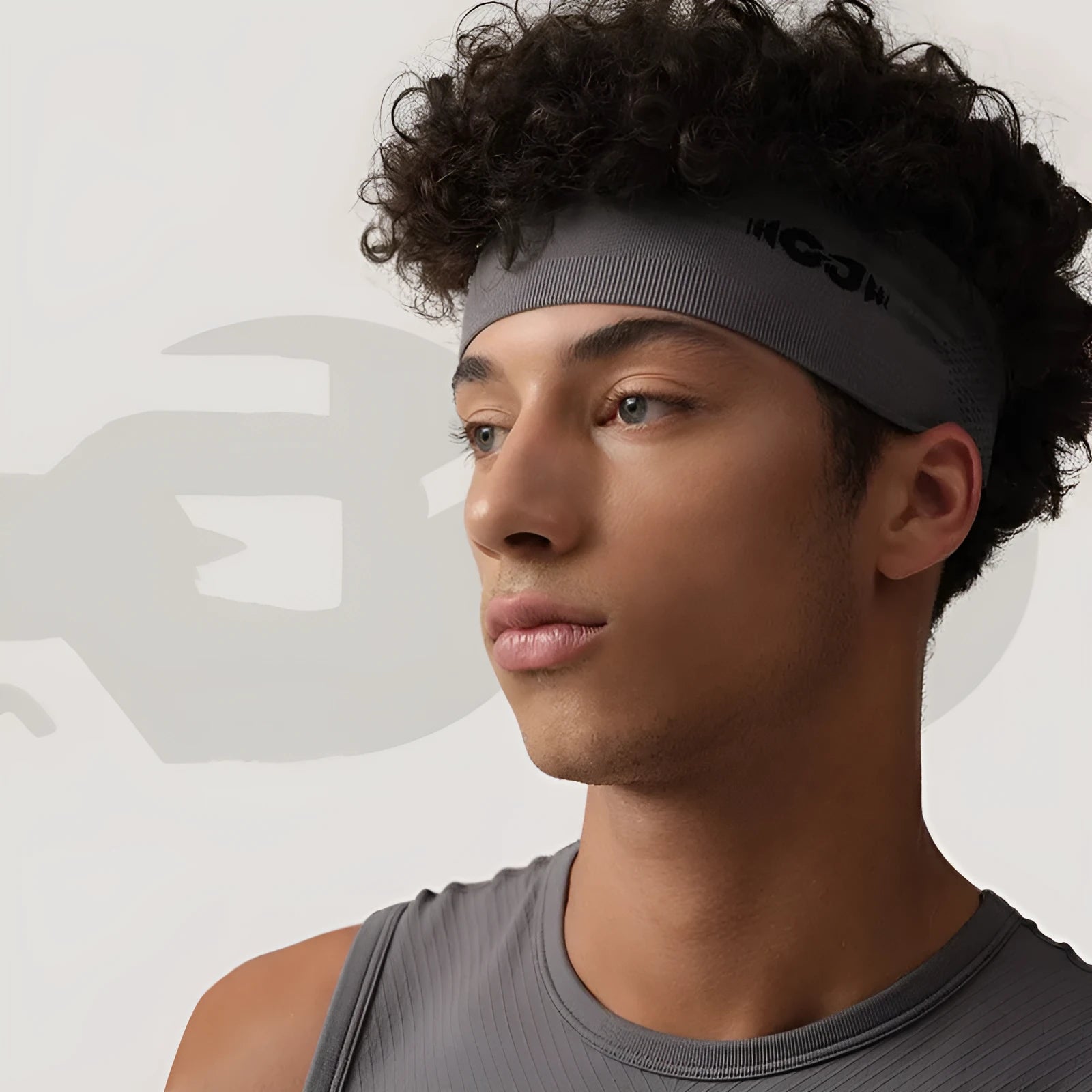 Seamless knitted exercise hair band in classic black, carbon grey, and purplish blue colours laid flat.