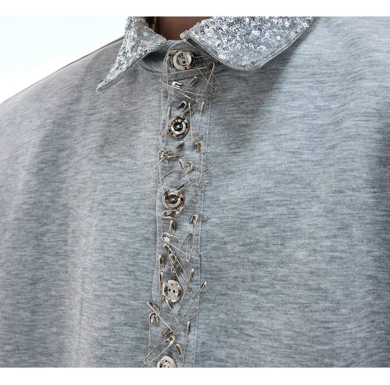 Women's loose black shirt with sequined square neckline and short sleeves on a hanger.