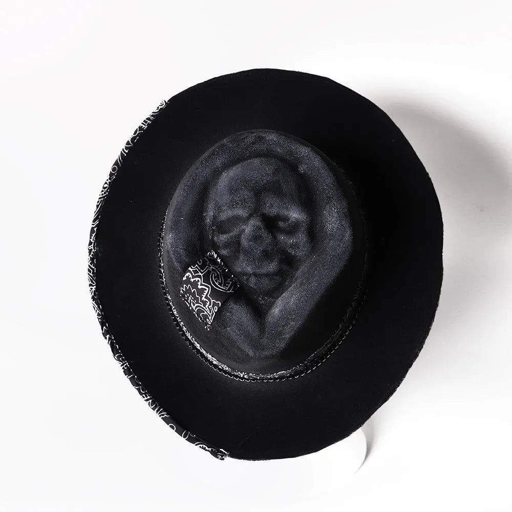 Handmade wool felt Halloween hat with a conical crown in a skull design.