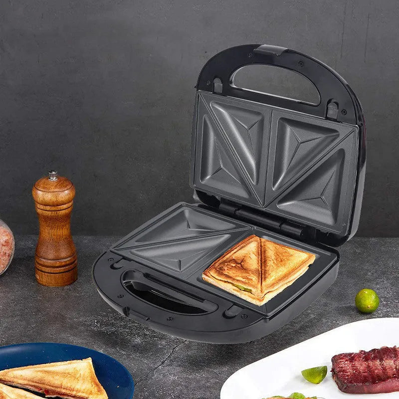 Black double-sided electric sandwich pan with stainless steel lid and six non-stick baking pans.