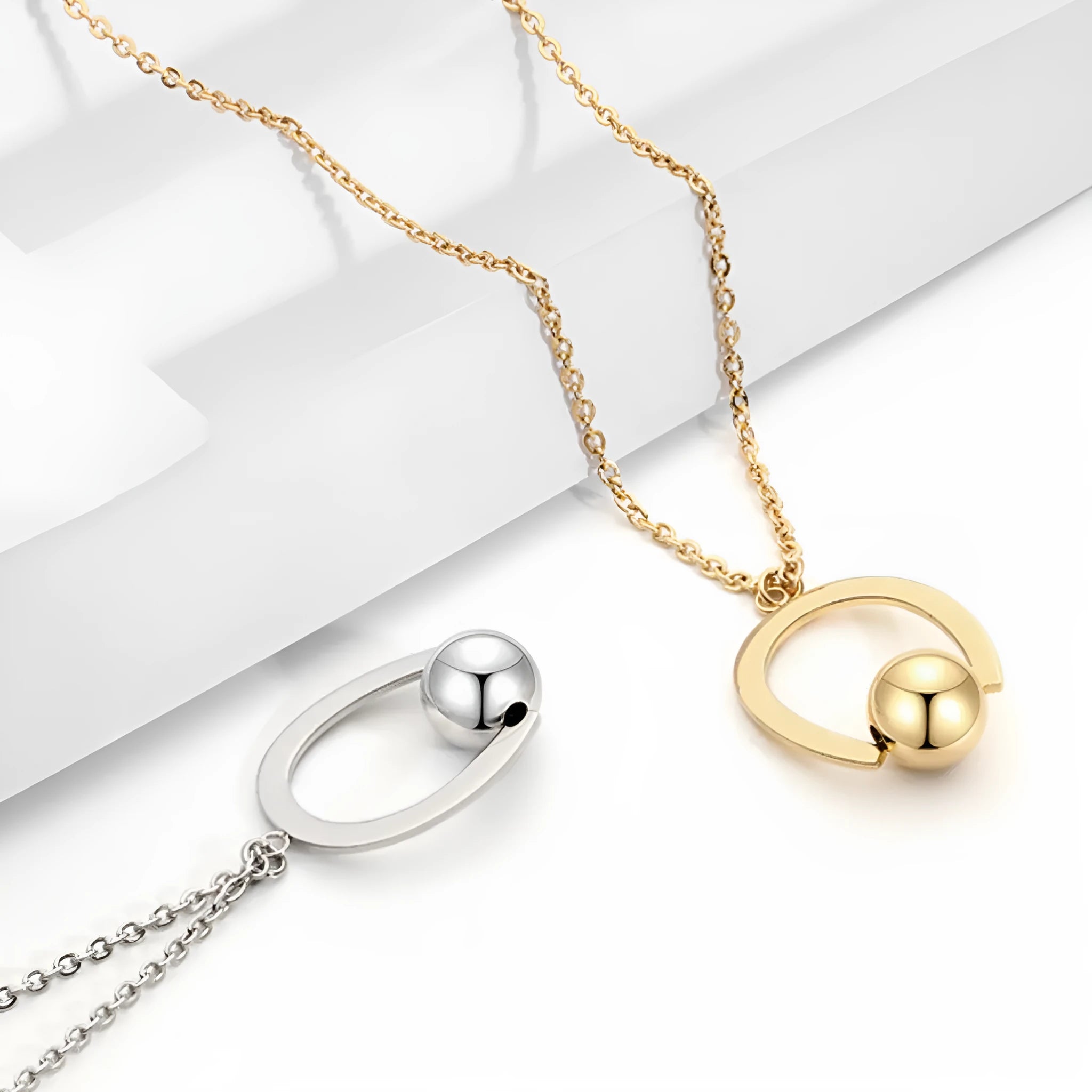 Adjustable stainless steel necklace with geometric pendant on a cross chain in gold or silver.