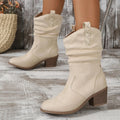 Women's suede mid-calf boots in lotus root colour with leather stitching and a mid heel.