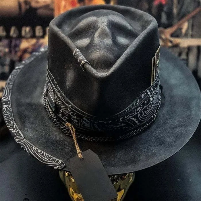 Handmade wool felt Halloween hat with a conical crown in a skull design.