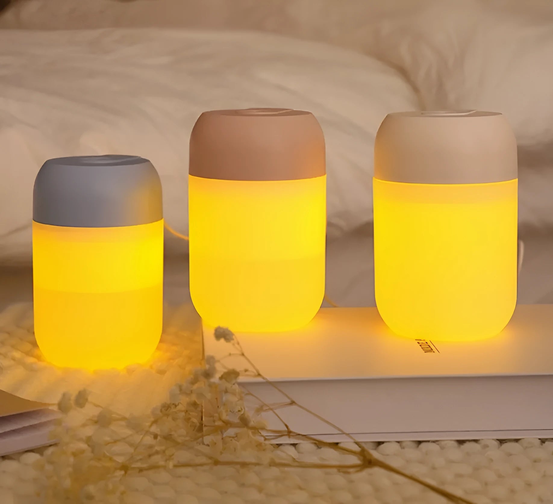 Small white cylindrical USB humidifier with charging cable for bedroom or desk use