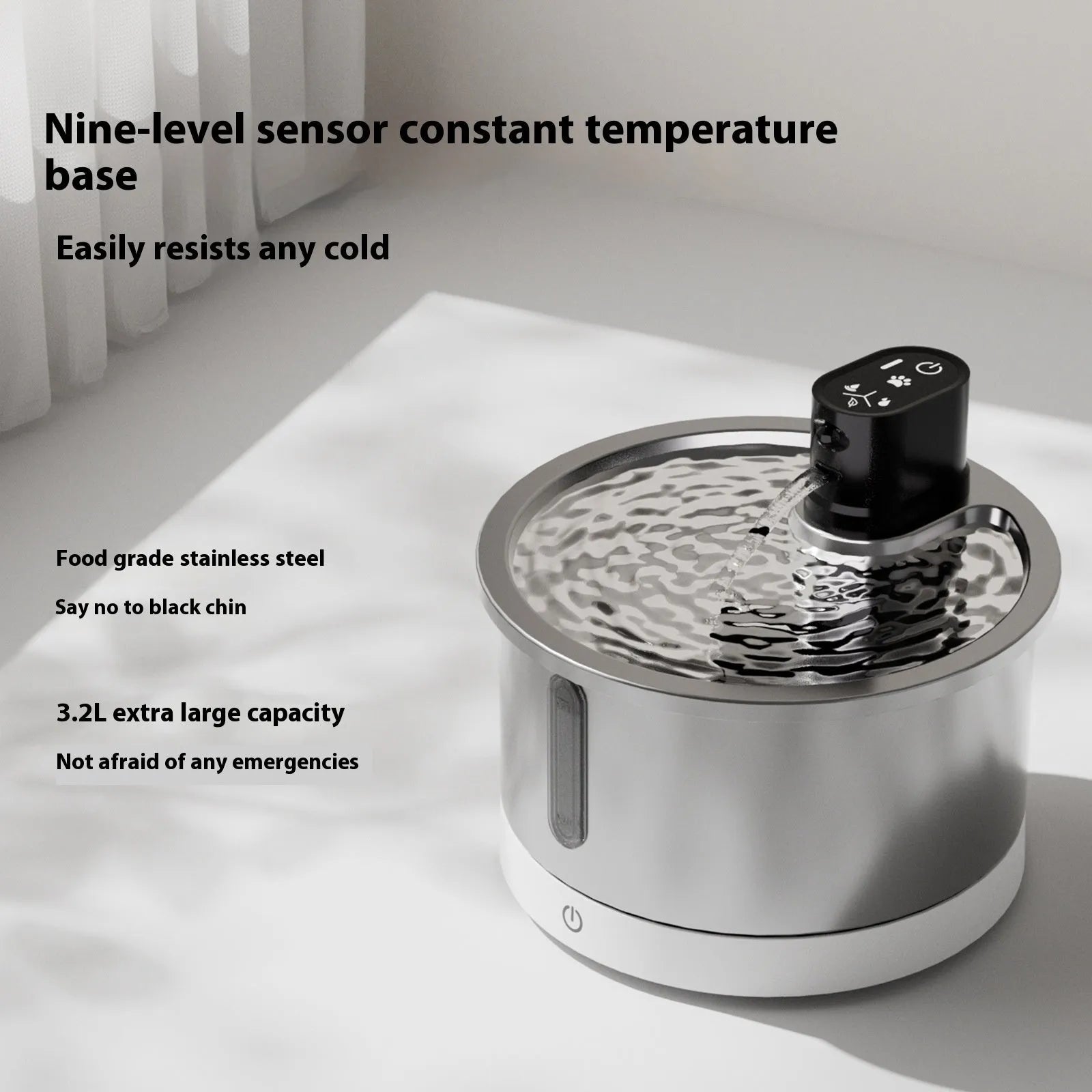 Stainless steel pet water fountain with a white heating base on a wooden floor.
