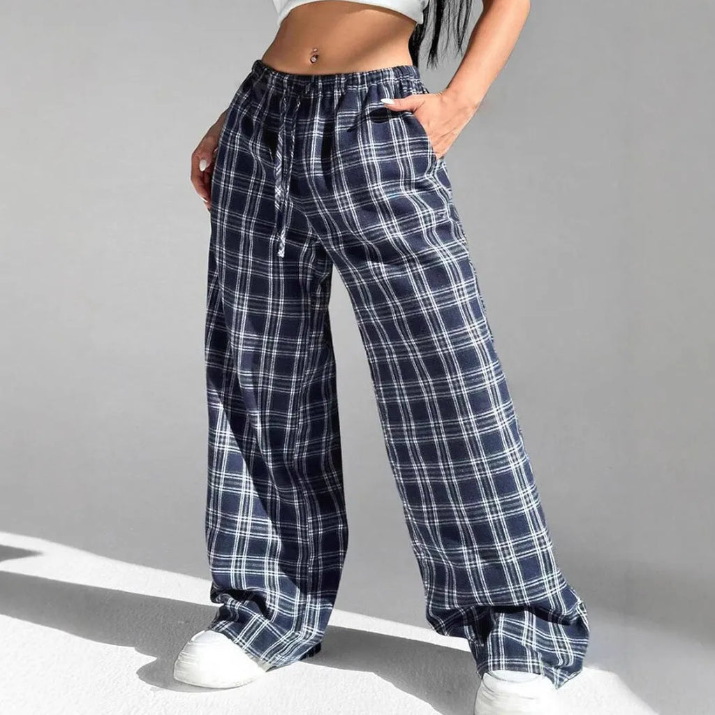 Women's red plaid trousers with drawstring waist and side pockets on mannequin display