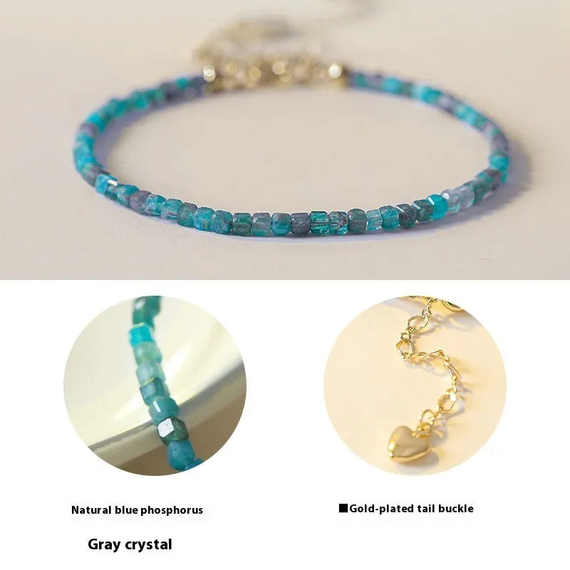 Women's blue and grey crystal bracelet with diamond faceted beads on a wrist.