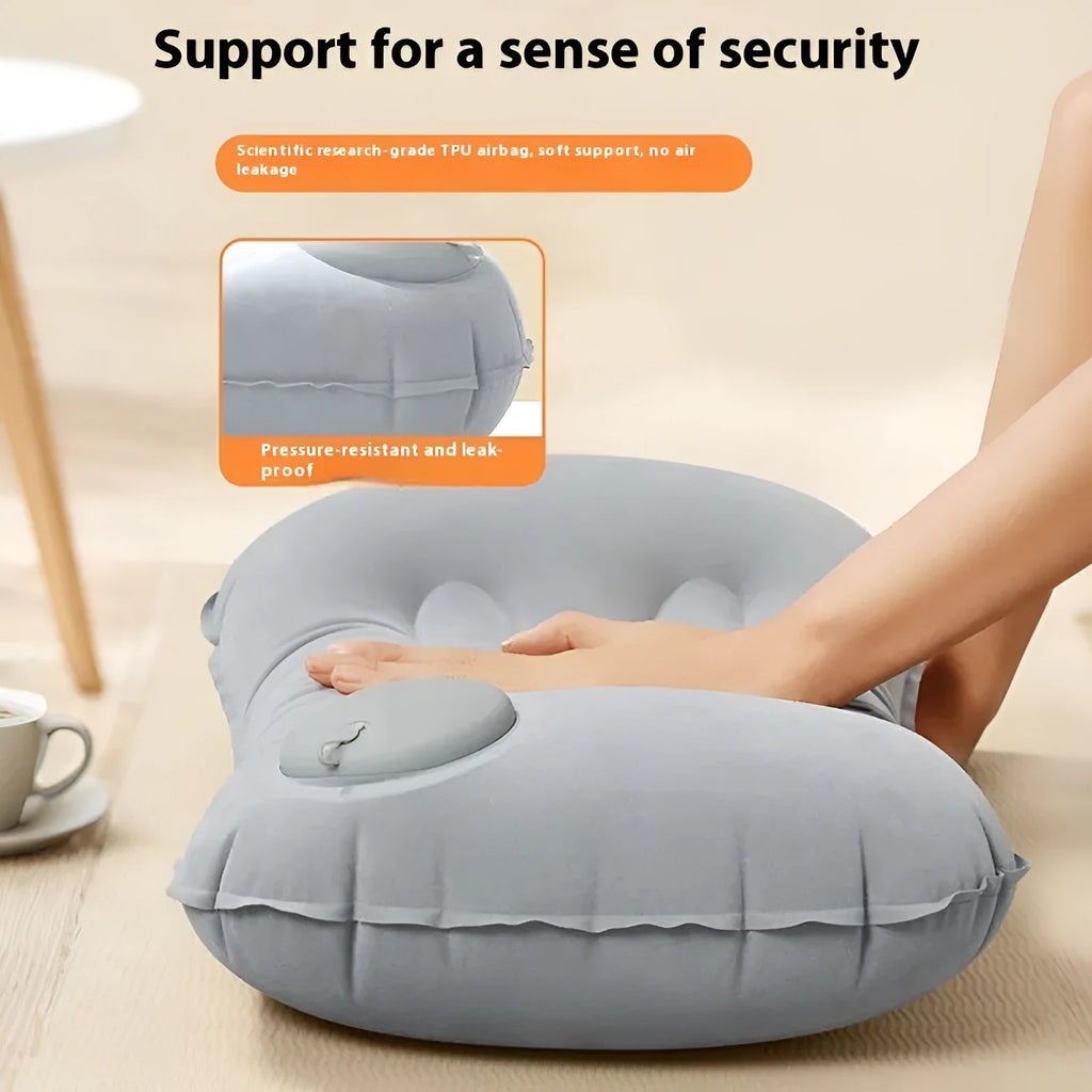 Gray inflatable travel pillow showing press valve, dimensions 45cm by 30cm.