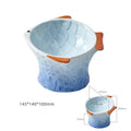 Blue fish-shaped ceramic cat bowl with tilted angle on a wooden surface