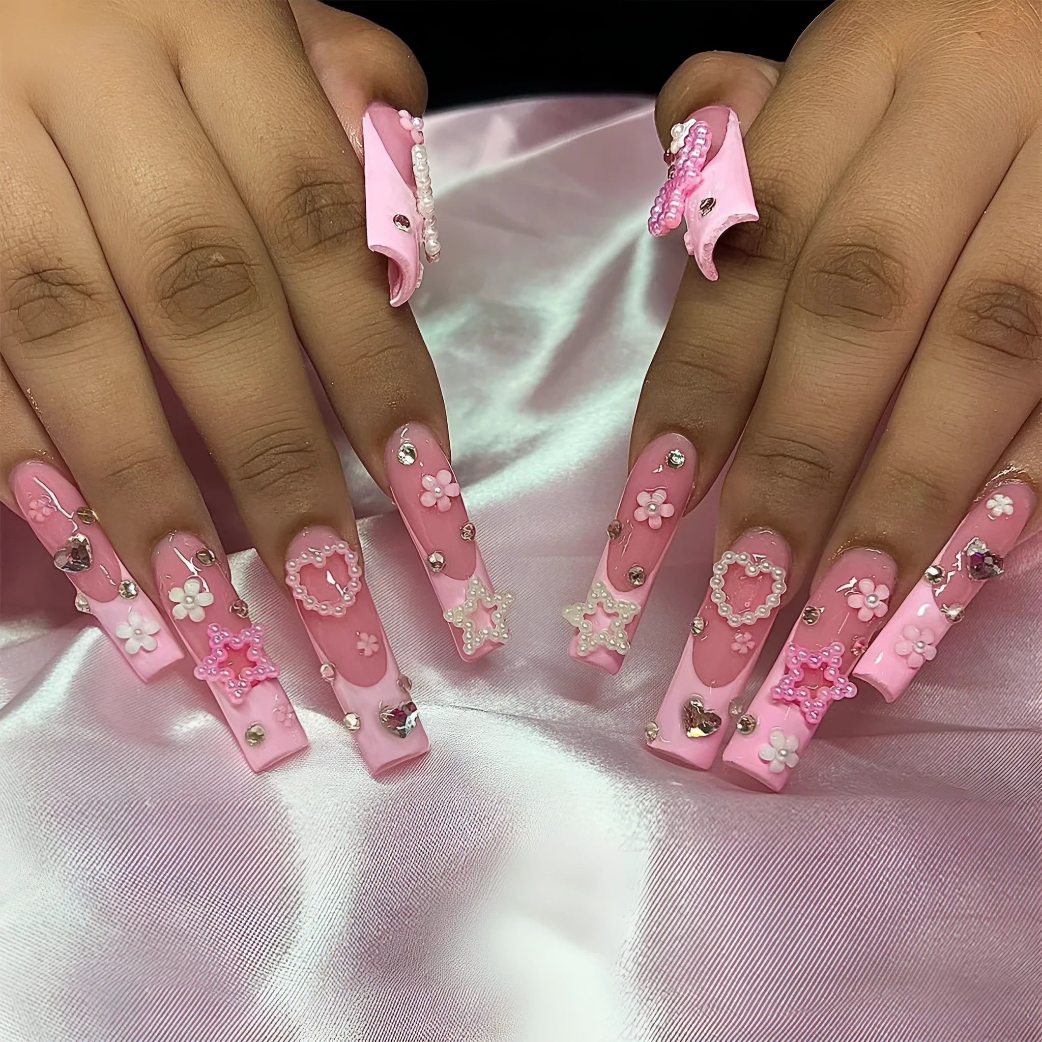 Super long false nails with French spot drill, a bow design, in XB-70-48 colour on a plastic armour suit.