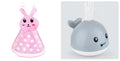 Whale-shaped electric bath toy with automatic water spray, LED lights, and music functions for baby sensory development