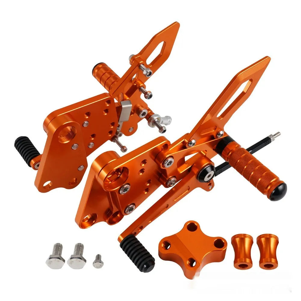 Black and orange KTM Duke motorcycle raised footrest bracket assembly