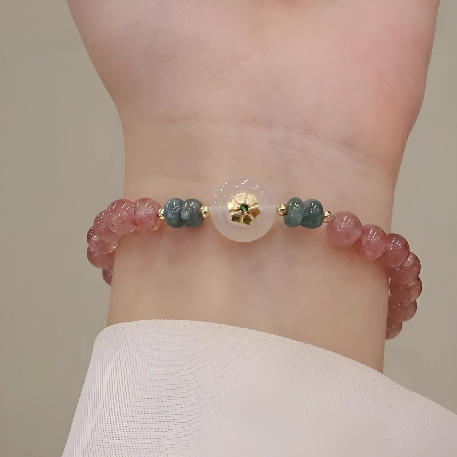 Strawberry quartz and blue water emerald pendant bracelet with round jade centrepiece and geometric diamond elements