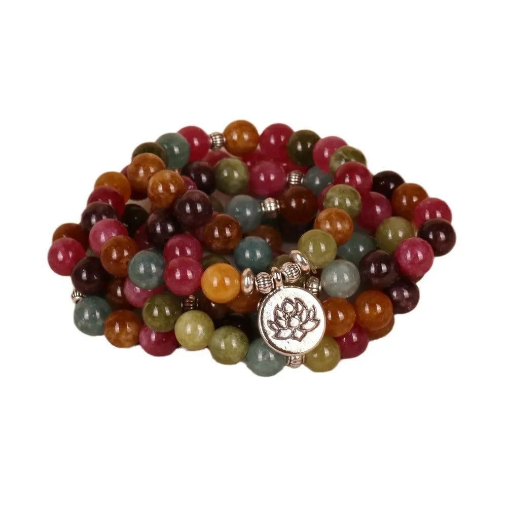 108-bead multi-layer bracelet with hanging lotus ornament in tourmaline-coloured alloy.