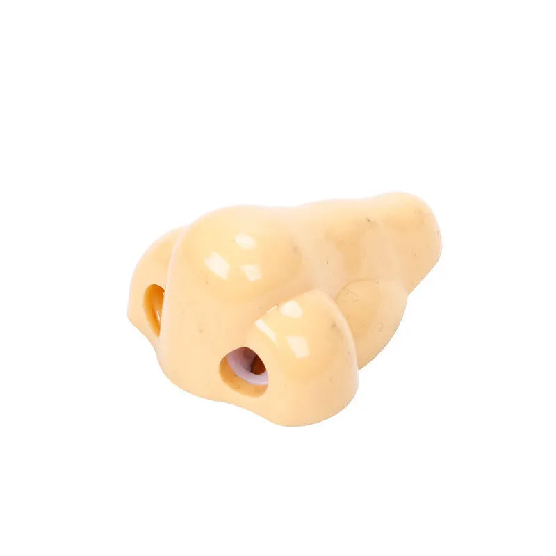 Flesh-coloured geometric pencil sharpener with a big hole for large pencils on a white background.