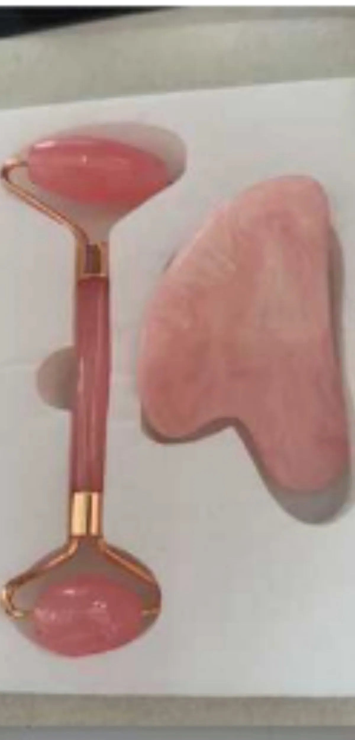 Two-piece resin gua sha roller set for face massage in black, pink, and green jade handle options