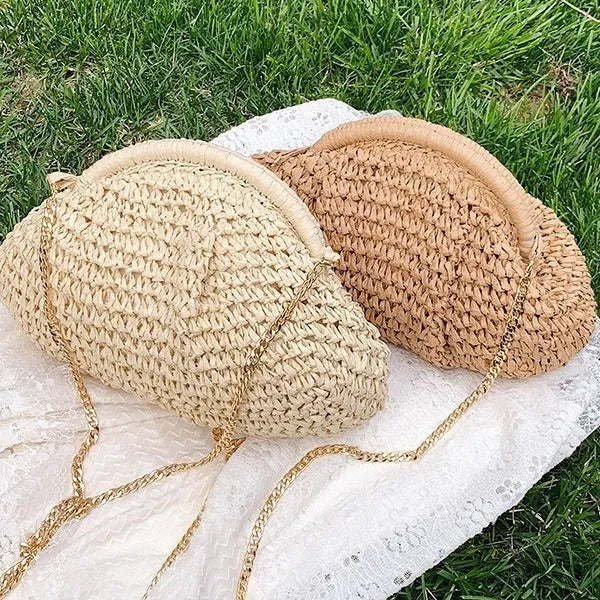 Women's beige shell-shaped paper straw bag with a metal chain strap.