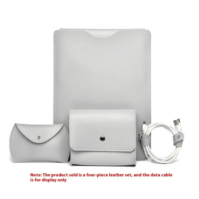 Set of four brown imitation leather laptop corner protectors on a grey laptop.
