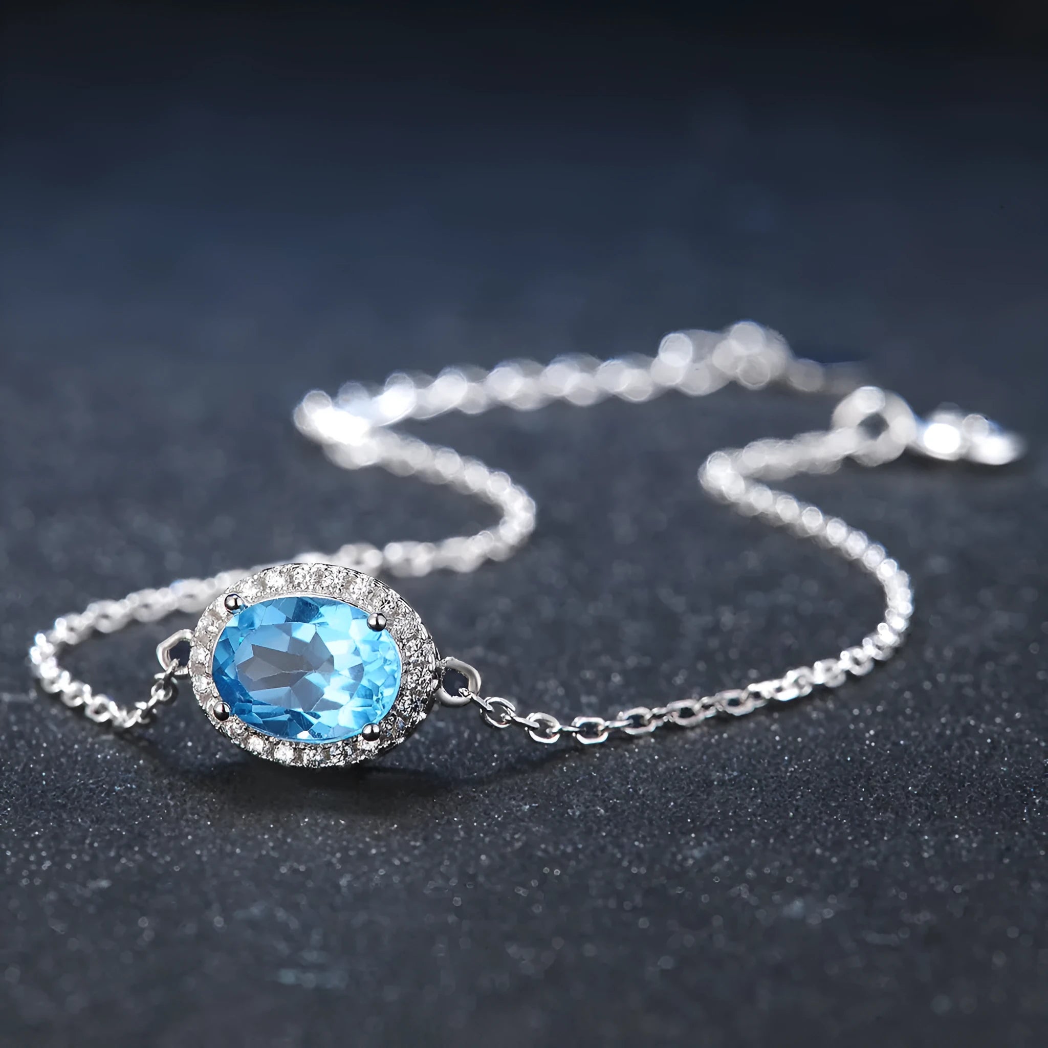 925 sterling silver jewellery set with blue topaz gemstones including earrings, ring, pendant and necklace