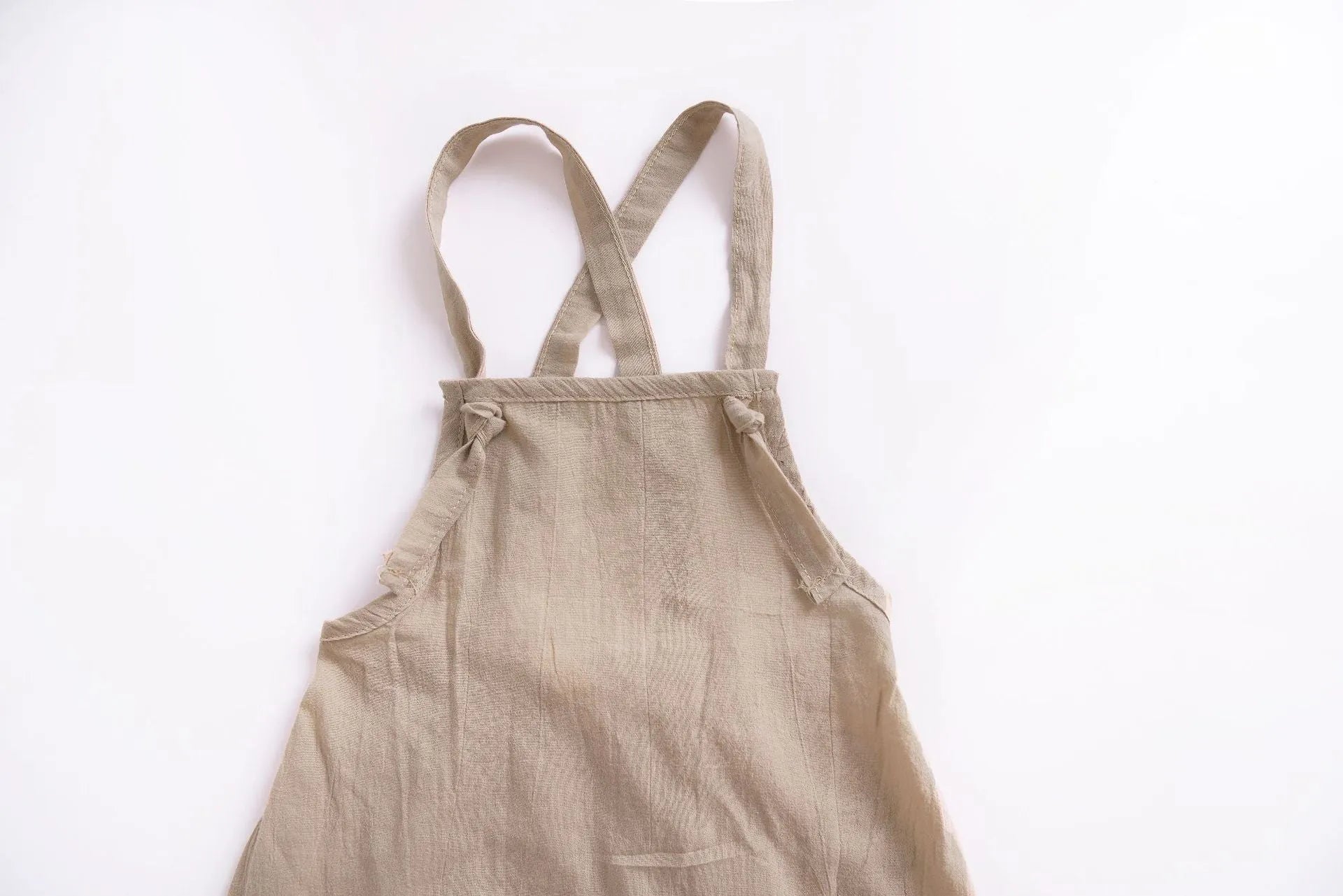 Children's khaki cotton overalls shorts with bow detail and straps, front view