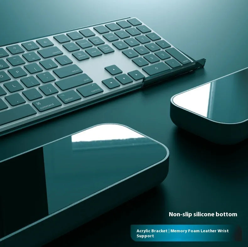 Double-sided keyboard and mouse pad with memory foam wrist rest on a resin base.