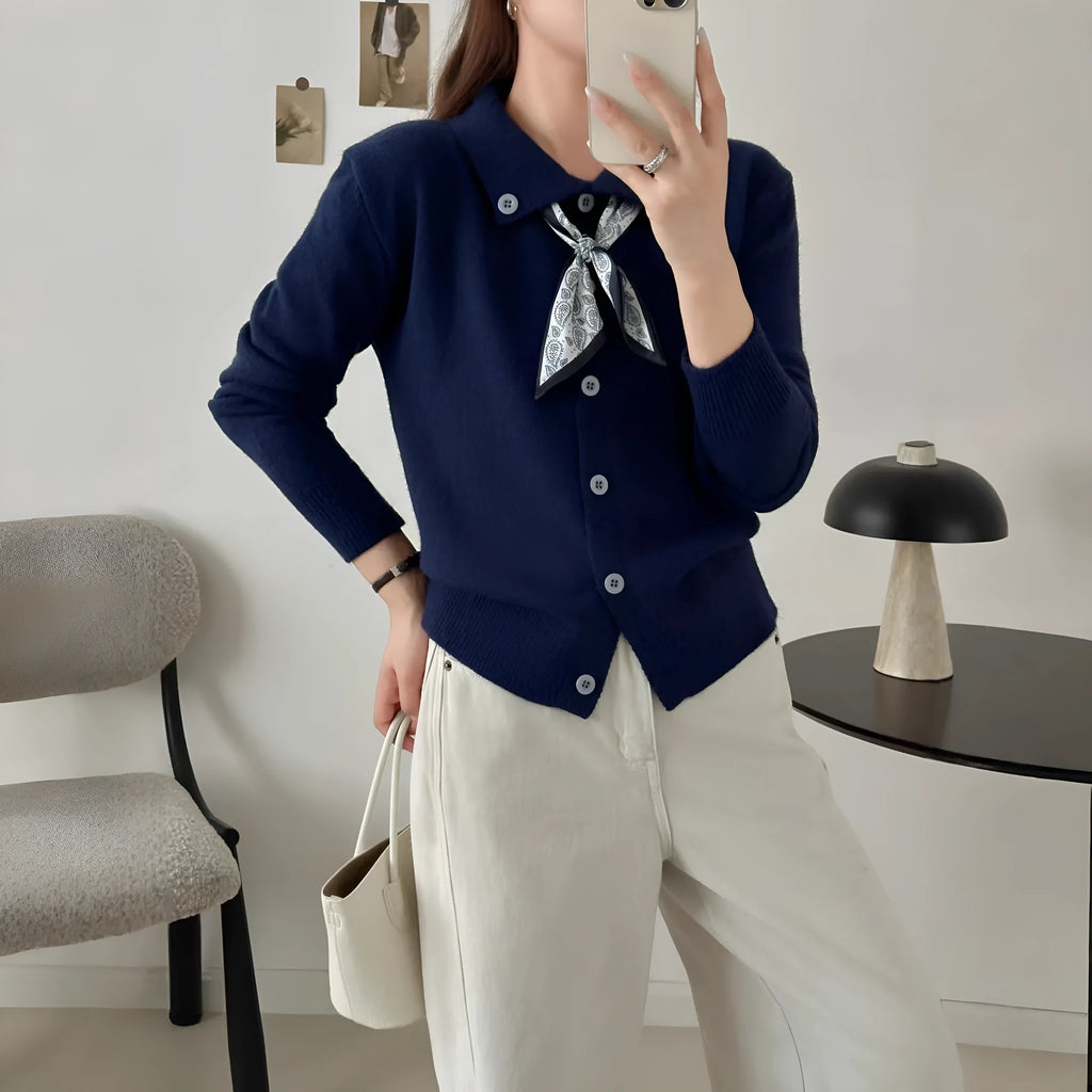 Acrylic fibre lazy fashion cardigan sweater with integrated lapel scarf in a neutral colour.