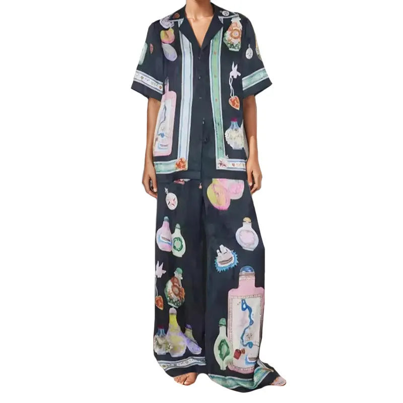 Black women's cardigan and trouser set with cartoon print, showing front view.