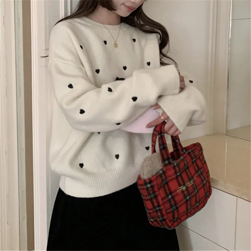 Women's loose long sleeve pink sweater with embroidered love pattern detail