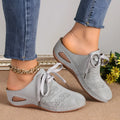 Women's suede lace-up wedge sandals in light grey showing hollow-out design and rubber sole