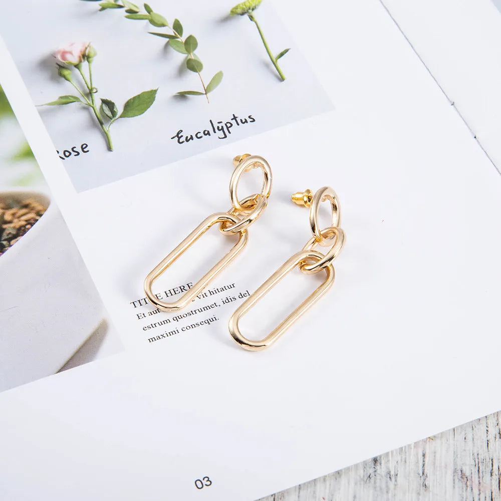 Women's sterling silver colour geometry hoop earrings showing ring and line design elements
