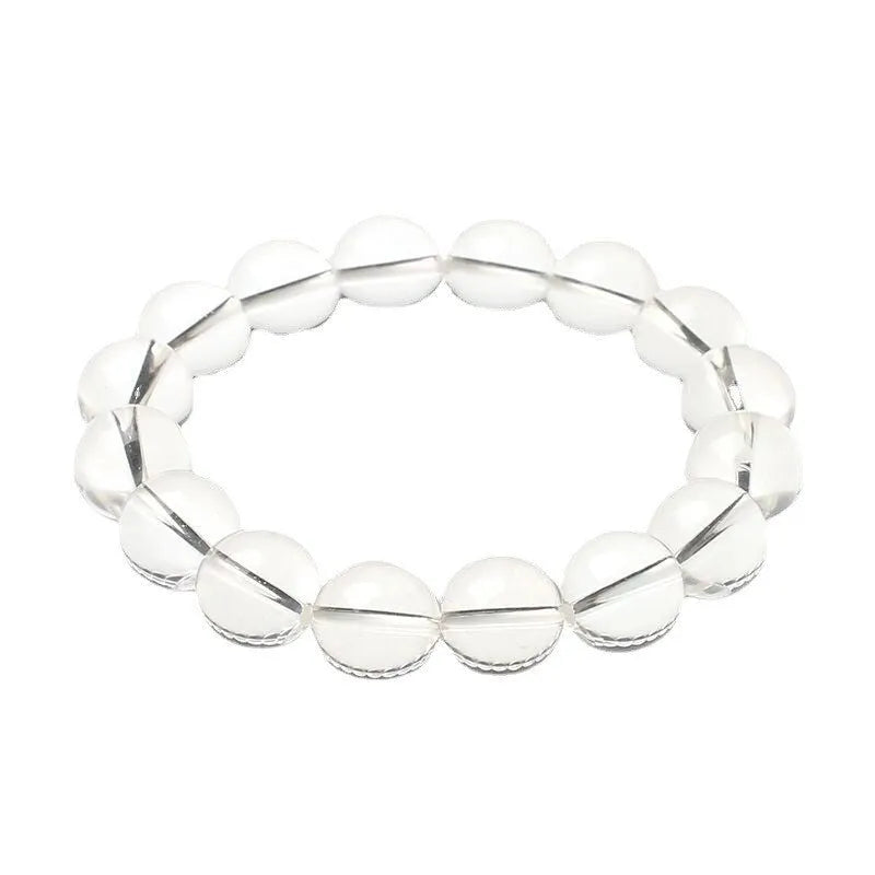 Natural Donghai old materials white crystal geometric bracelet with round beads on a wrist.