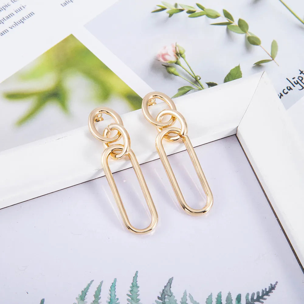 Women's sterling silver colour geometry hoop earrings showing ring and line design elements