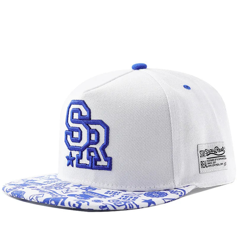 Cotton baseball cap with embroidered lettering on the front, shown in black and white colours