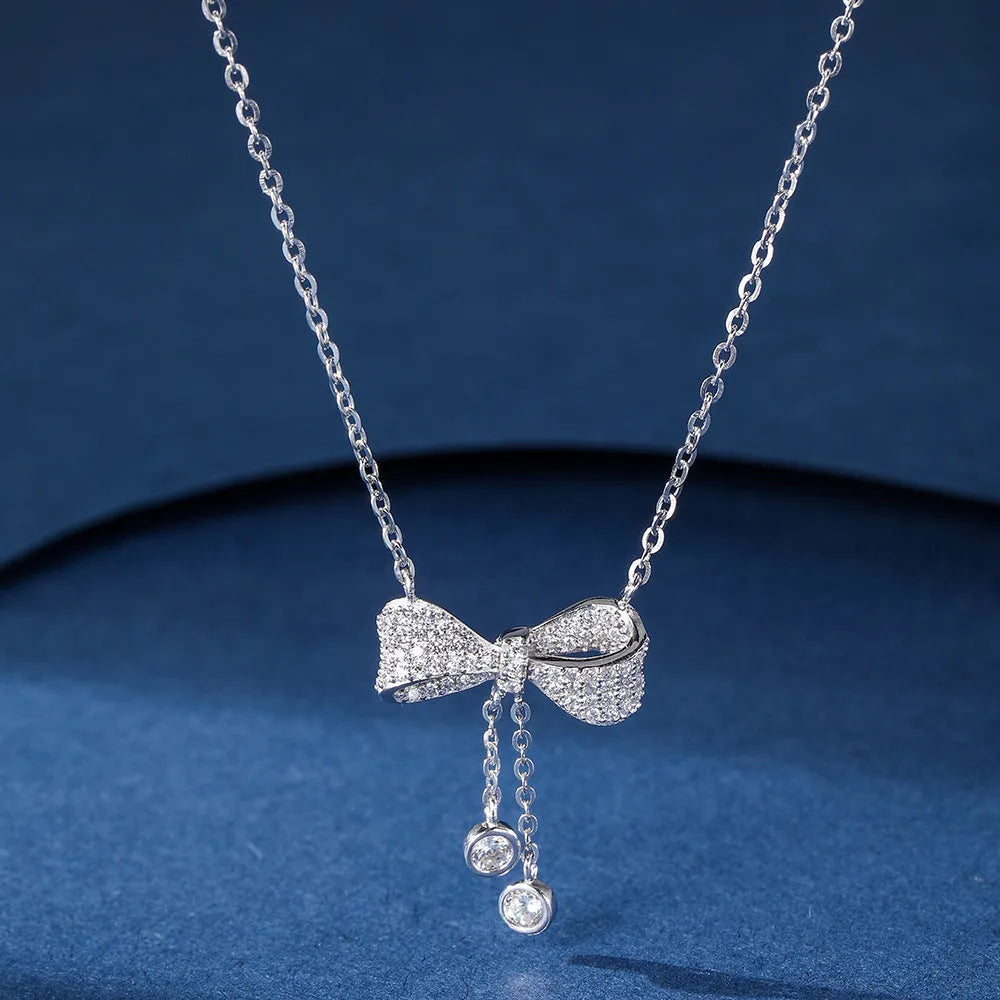 S925 sterling silver necklace with a bow pendant on an O-ring chain.