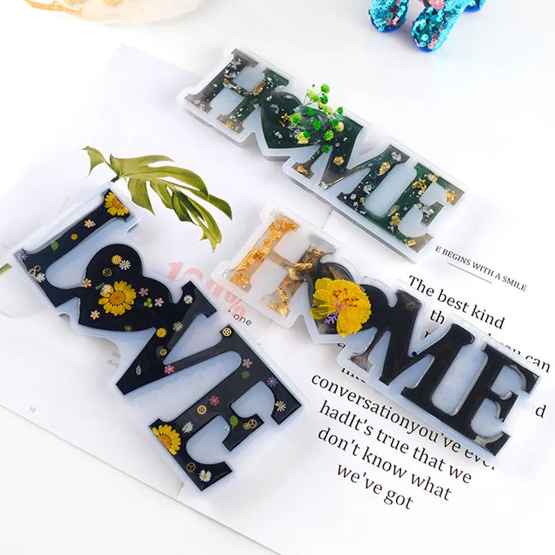 Silicone epoxy mould showing irregular shape with raised English alphabet letters for resin casting.