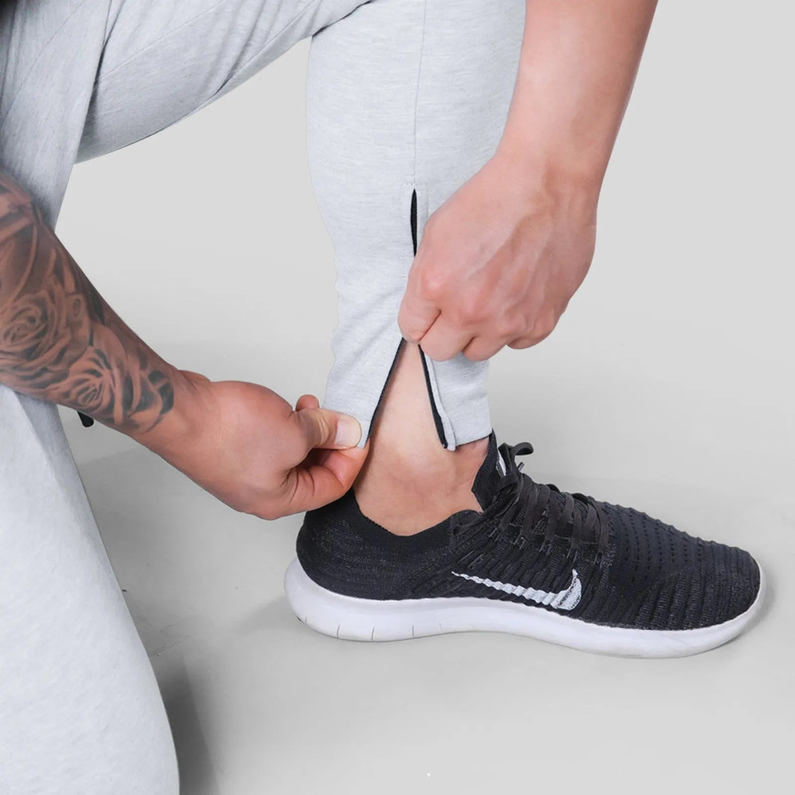 Men's polyester fitness training pants in green, black, navy blue and grey colours for gym workout and bodybuilding