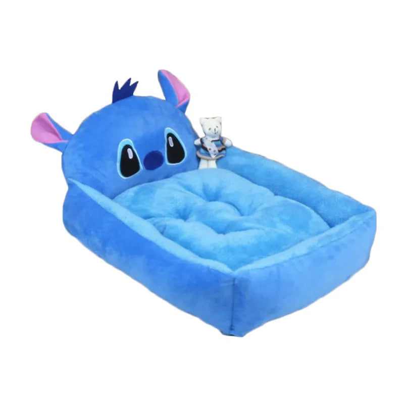 Blue sofa-style washable pet bed for a small dog on a wooden floor