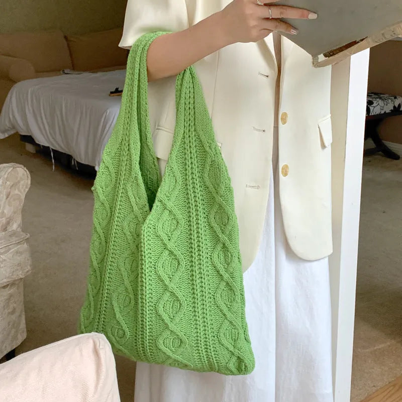 Retro hollow knitted woolen women's shoulder tote bag in a solid colour, showing double straps and large capacity.