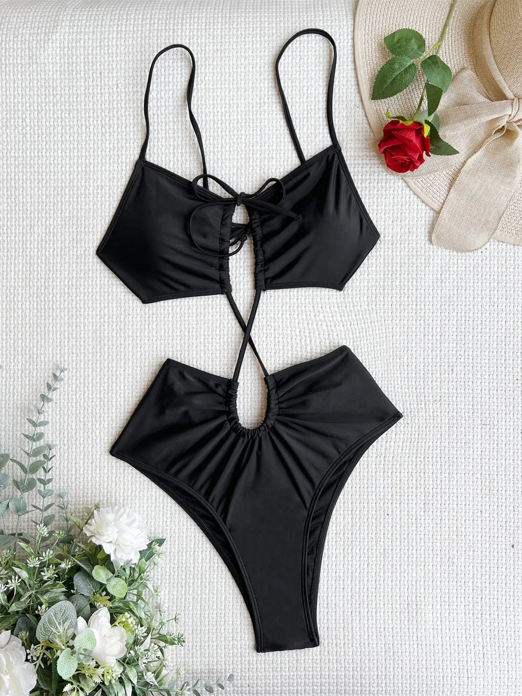 Women's green sleeveless one-piece swimsuit with a hollow cutout back design on a mannequin.